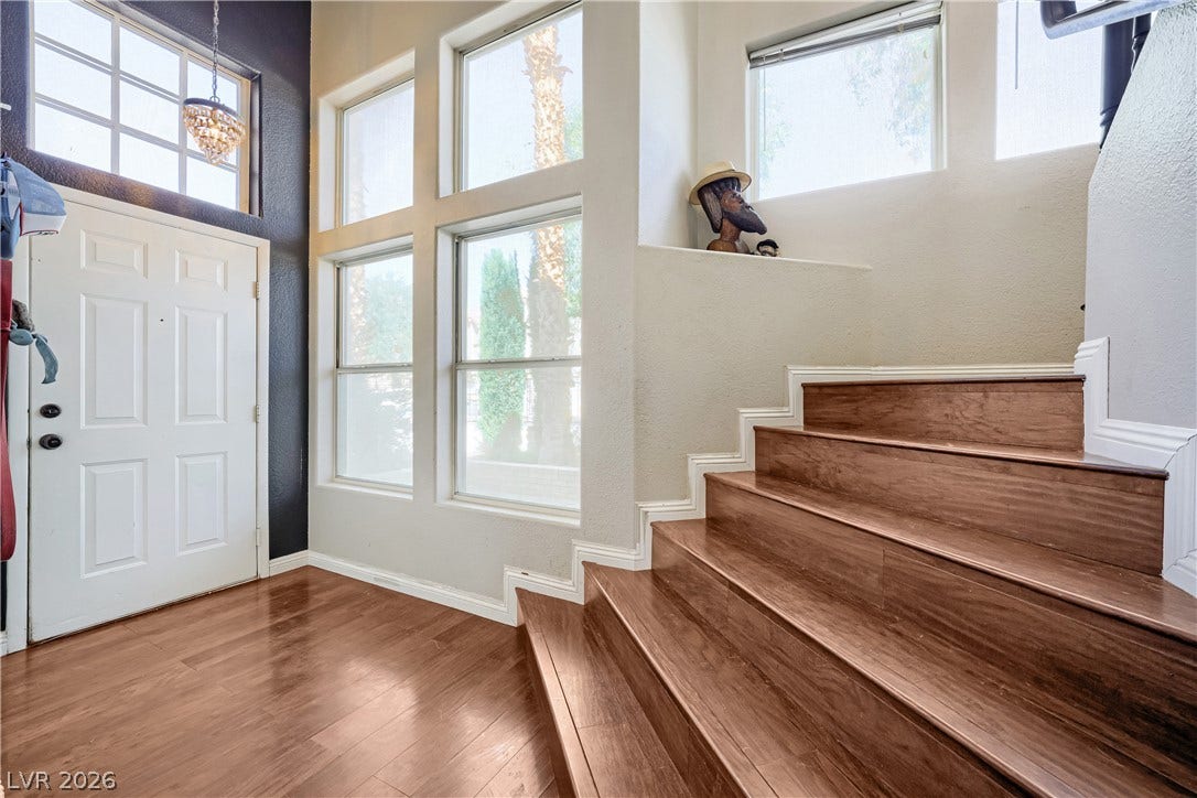 3536 Golden Pedal Street, Las Vegas, NV 89129 Gleaming hardwood floors and a soaring multi-story window wall illuminate this welcoming entryway.