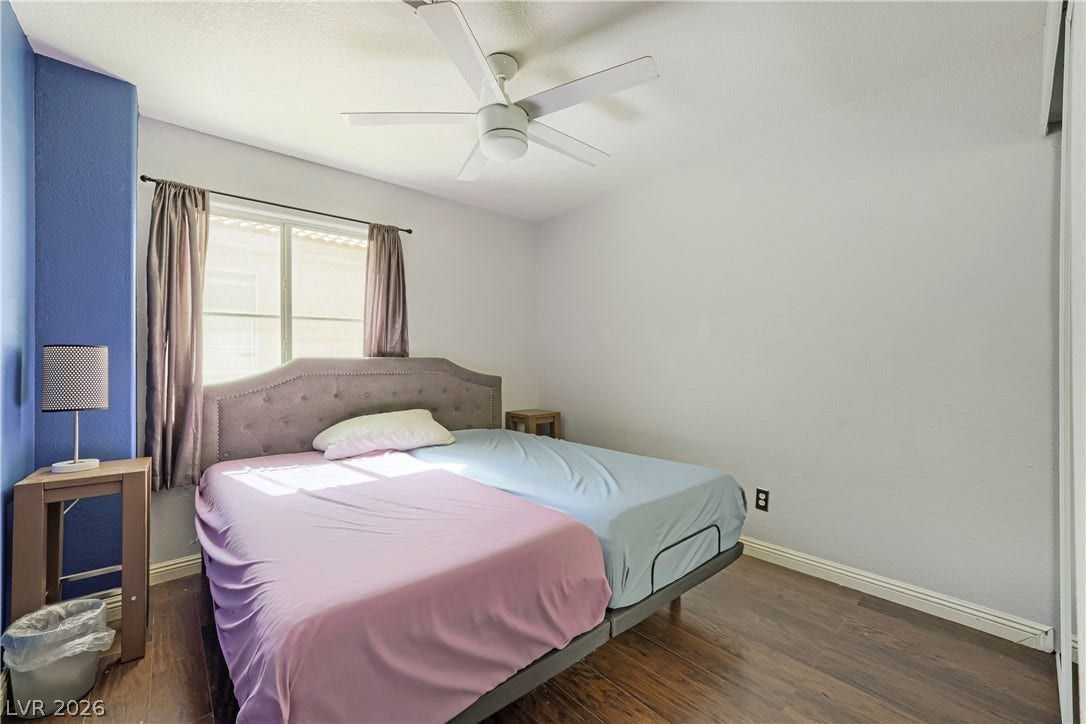 3536 Golden Pedal Street, Las Vegas, NV 89129 Rich wood flooring pairs with clean white walls under a modern white ceiling fan.