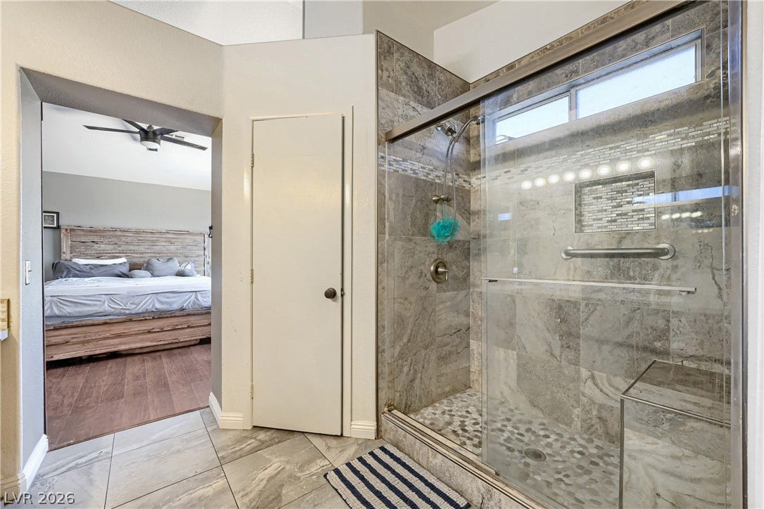 3536 Golden Pedal Street, Las Vegas, NV 89129 A tiled walk-in shower highlights this bathroom, which connects directly to the adjoining bedroom.