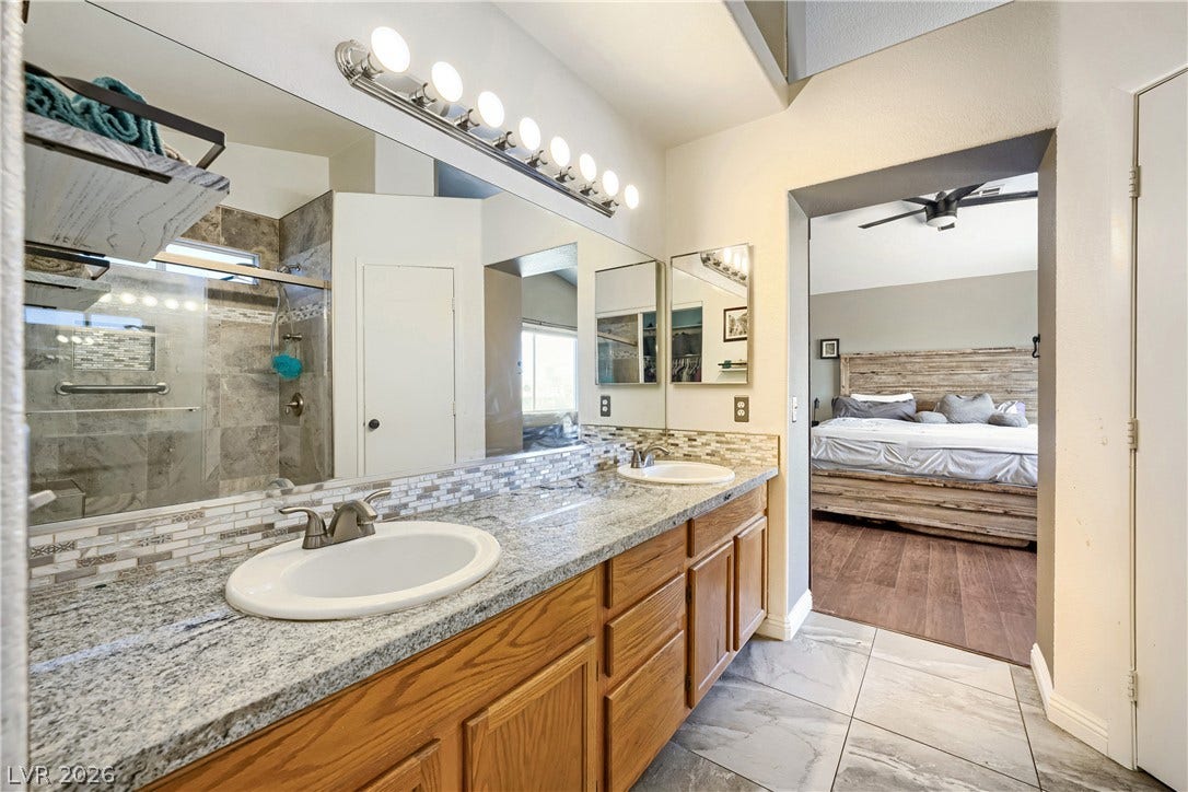 3536 Golden Pedal Street, Las Vegas, NV 89129 Granite counters and double sinks complement the tiled floors in this master bathroom.