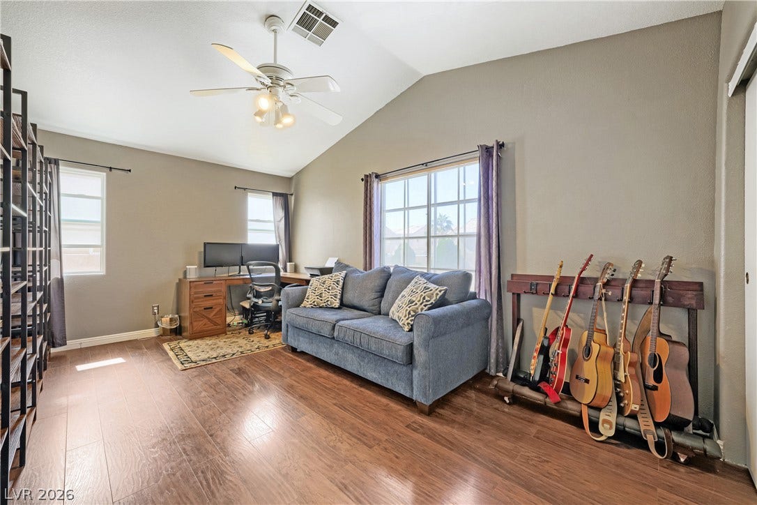 3536 Golden Pedal Street, Las Vegas, NV 89129 Rich hardwood flooring complements the vaulted ceiling of this versatile living space.