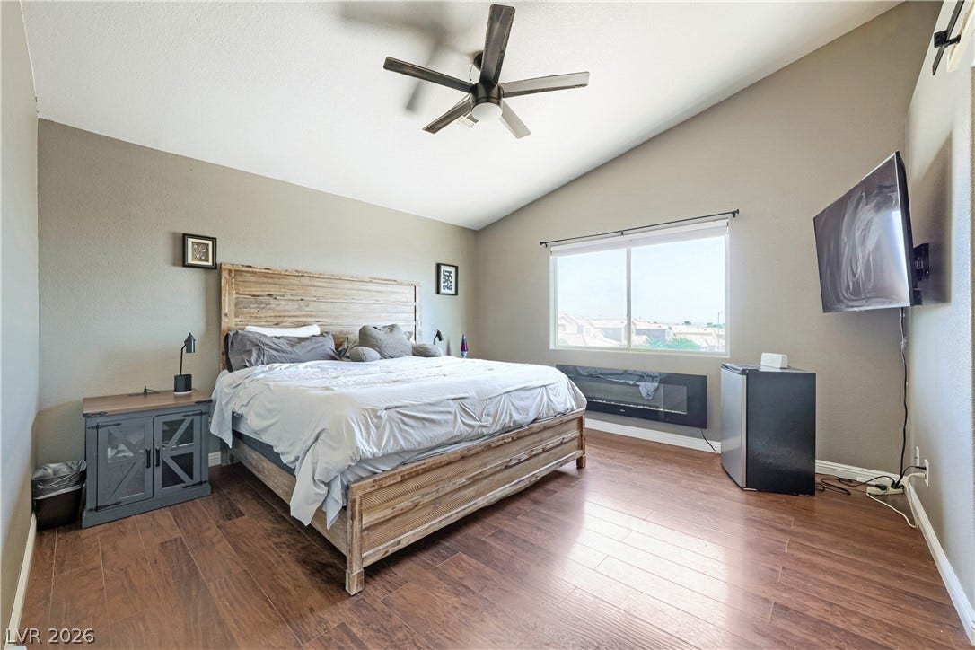 3536 Golden Pedal Street, Las Vegas, NV 89129 Gleaming hardwood floors and a vaulted ceiling elevate this airy bedroom.