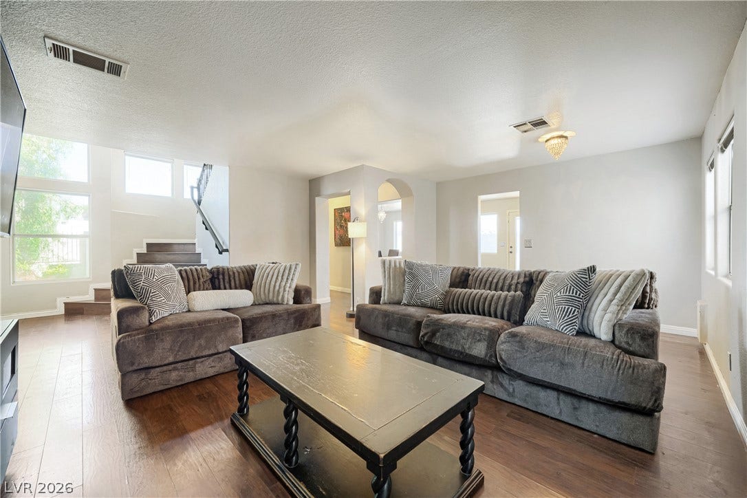 3536 Golden Pedal Street, Las Vegas, NV 89129 Gleaming hardwood floors run throughout this open main living space with high ceilings.