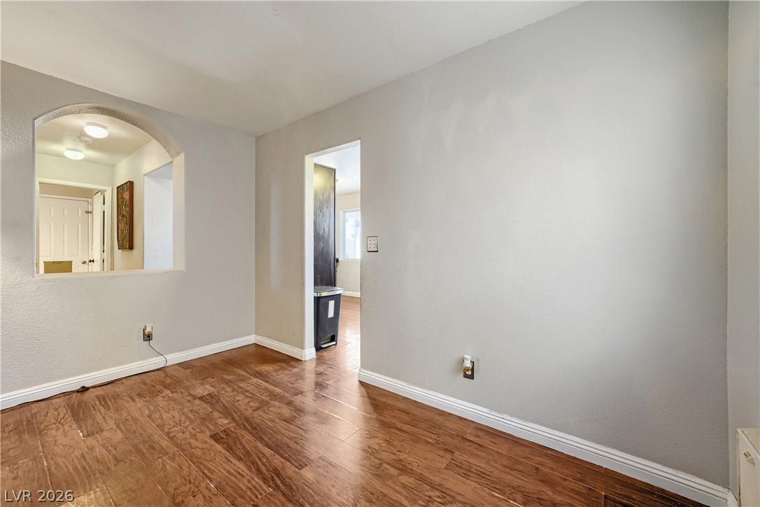 3536 Golden Pedal Street, Las Vegas, NV 89129 Gleaming hardwood floors and a unique arched wall cutout define this versatile interior space.