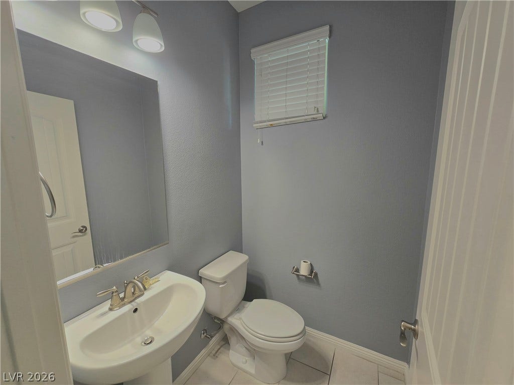 2926 Tremont Avenue, Henderson, NV 89052 A classic pedestal sink and clean tile flooring define this charming powder room.
