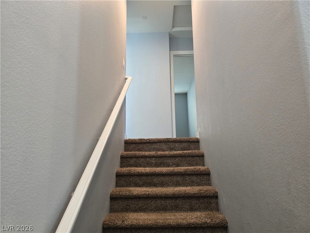 2926 Tremont Avenue, Henderson, NV 89052 Carpeted stairs ascend to a bright upper landing with smooth, neutral walls.