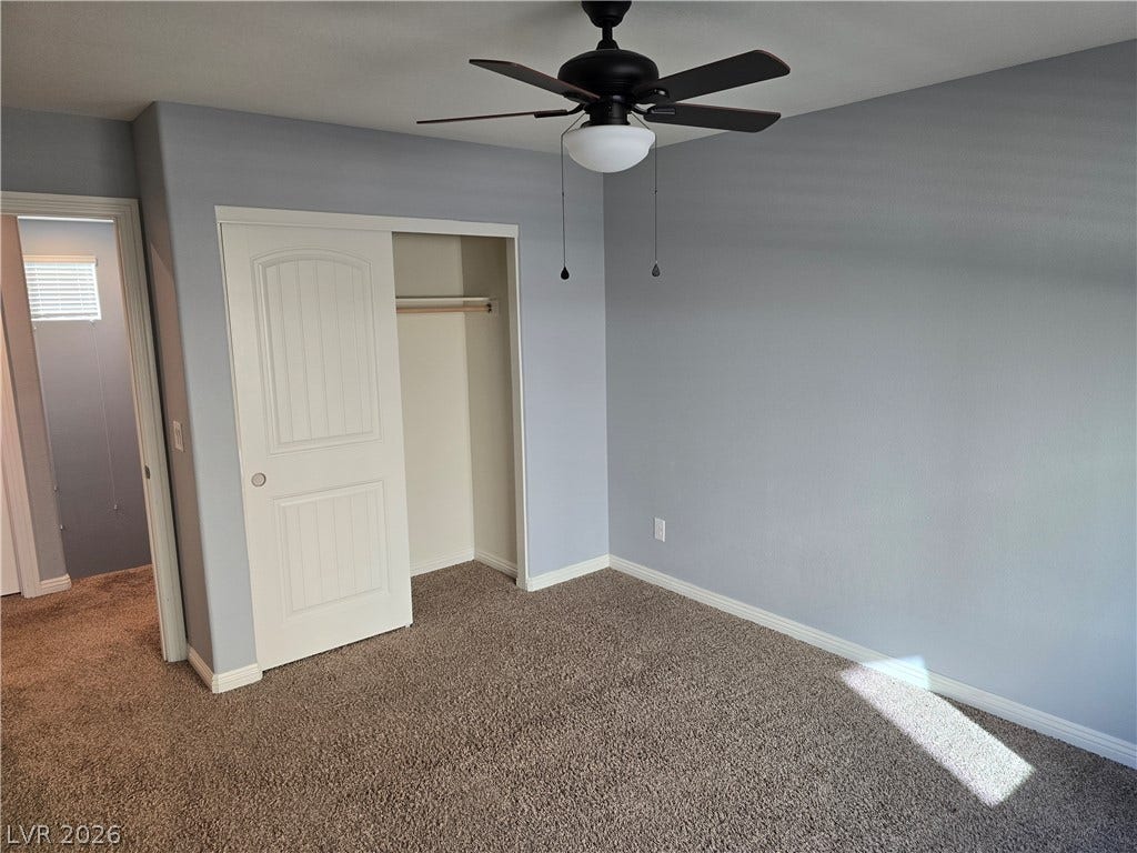 2926 Tremont Avenue, Henderson, NV 89052 Plush carpeting and a built-in closet anchor this versatile secondary bedroom space.
