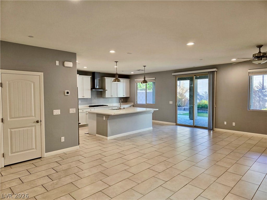 2926 Tremont Avenue, Henderson, NV 89052 An open floor plan seamlessly connects the kitchen and main living areas over tiled flooring.