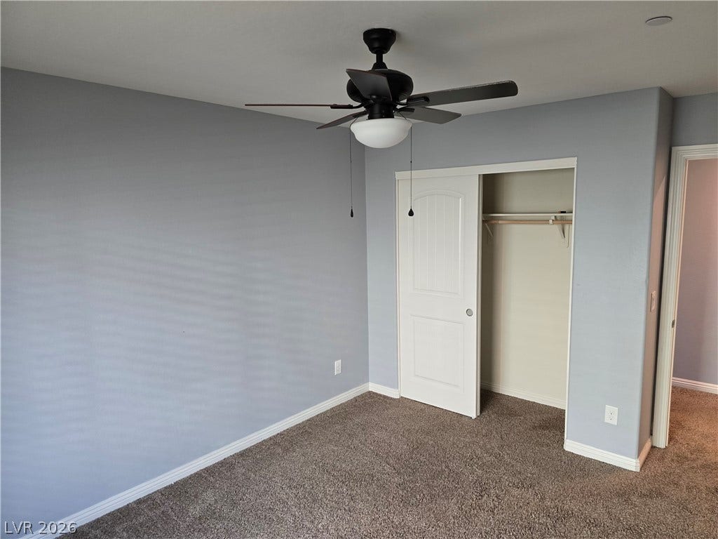 2926 Tremont Avenue, Henderson, NV 89052 Plush carpeting and a built-in closet define this versatile secondary bedroom space.