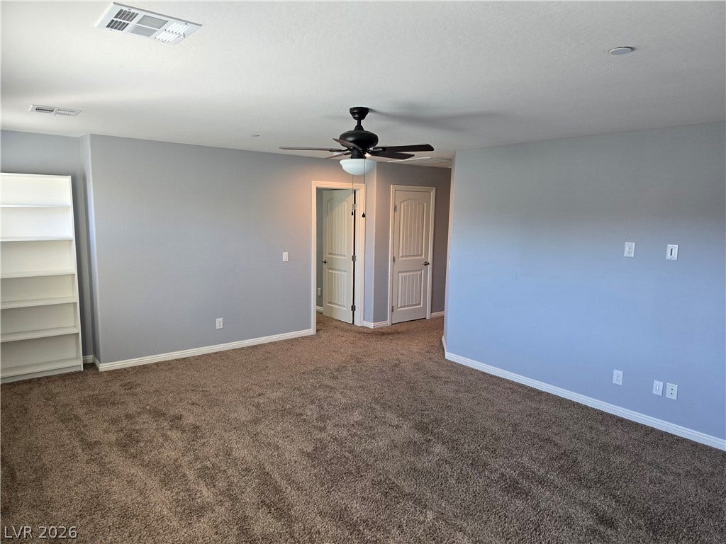 2926 Tremont Avenue, Henderson, NV 89052 Plush carpet anchors this versatile living space leading to adjoining rooms.
