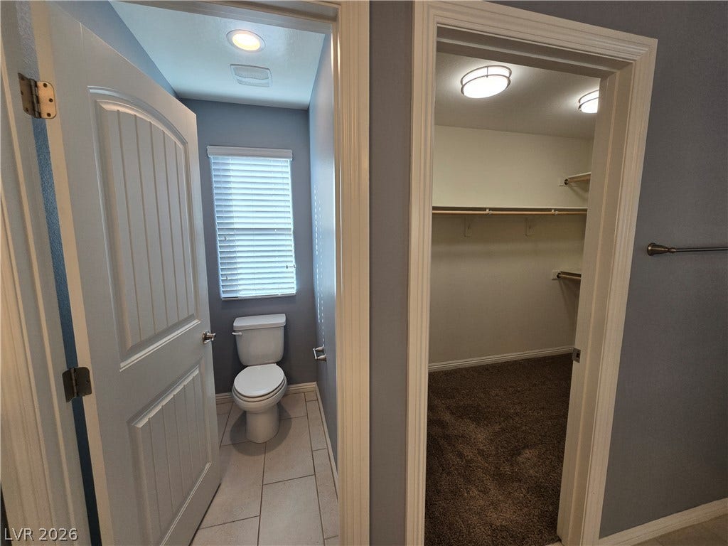 2926 Tremont Avenue, Henderson, NV 89052 A private water closet sits adjacent to a spacious walk-in closet featuring built-in shelving.