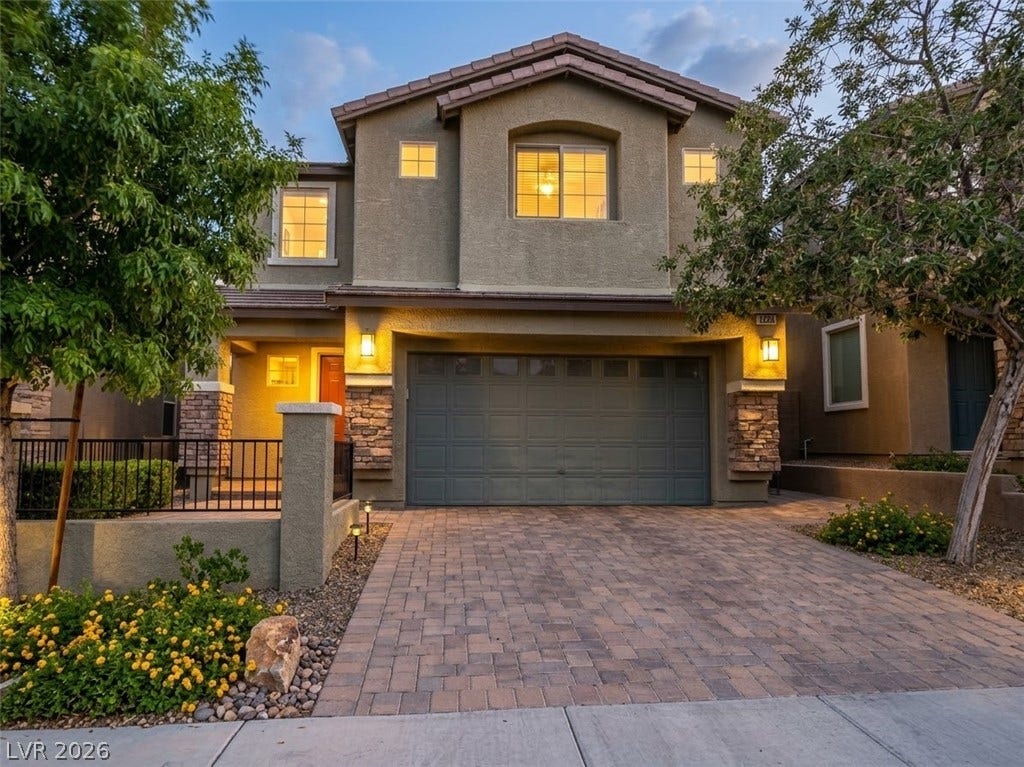 2926 Tremont Avenue, Henderson, NV 89052 An inviting stone-accented exterior displays a handsome paved driveway leading to the garage.