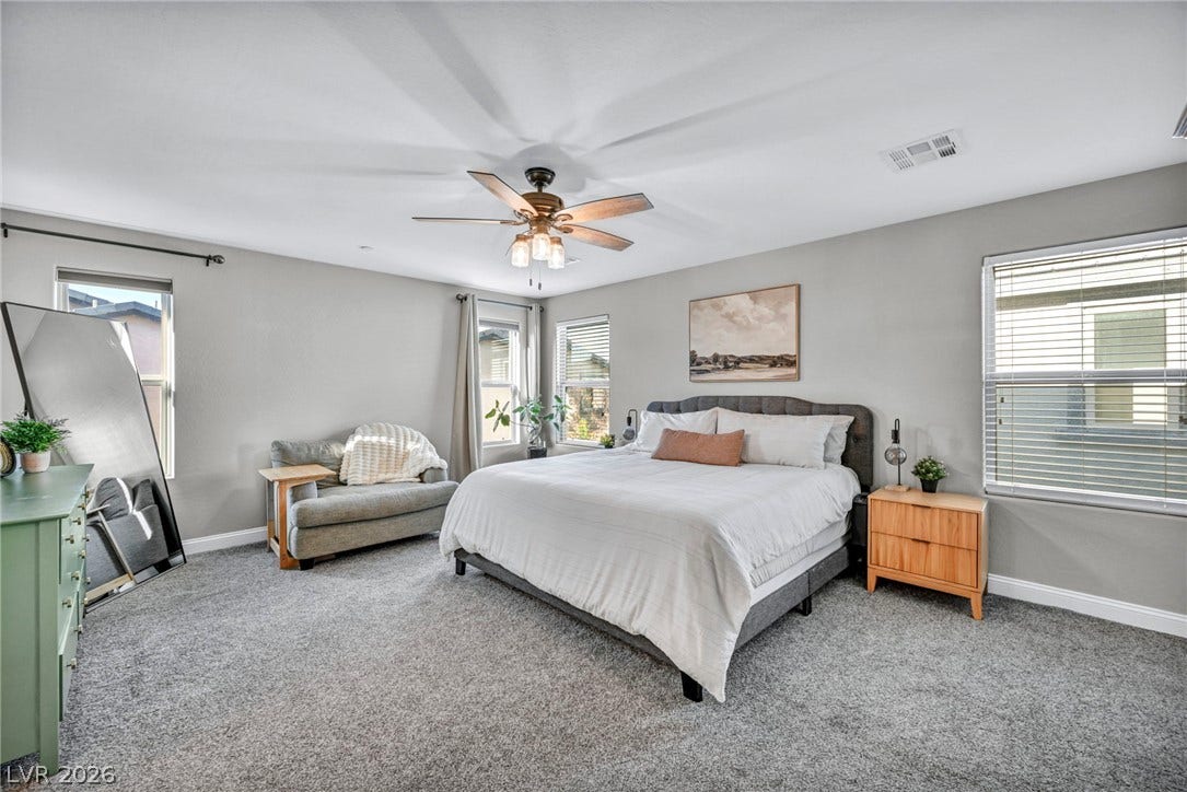 Generous windows fill this comfortable main suite with an abundance of natural light.