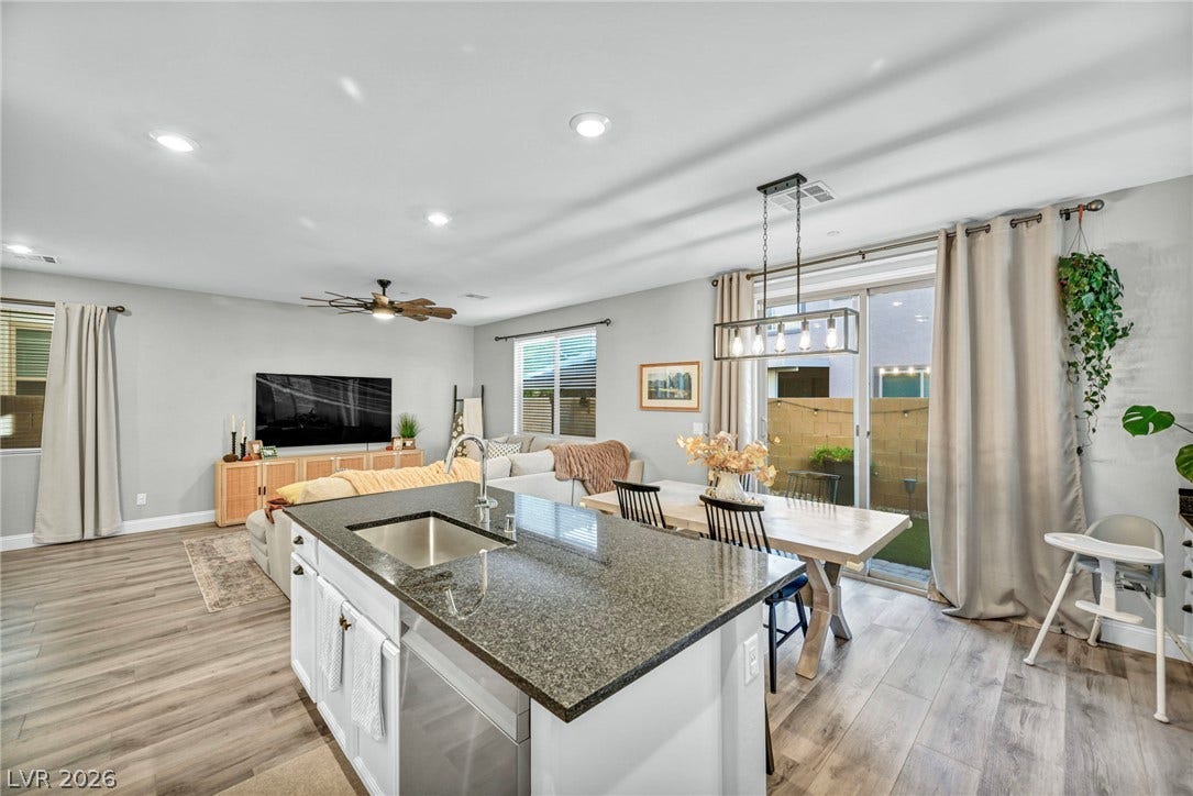 Polished granite counters and wood-look flooring anchors this open-concept main level.