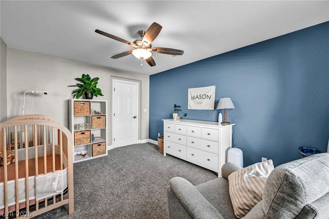 Plush carpeting underfoot complements this comfortably sized secondary bedroom.