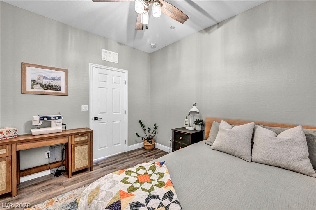 Smooth wood-look flooring and clean lines define this comfortable bedroom retreat.