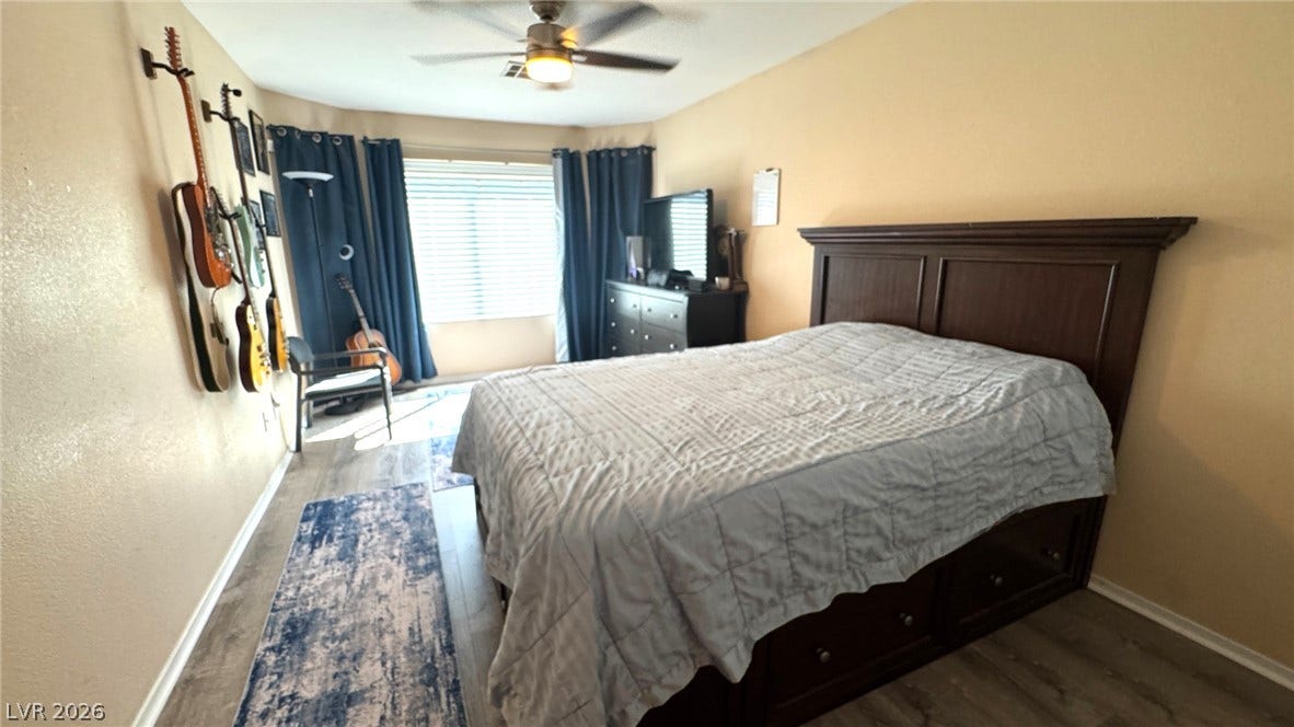 Smooth plaster walls and durable plank flooring frame this comfortable sleeping space.