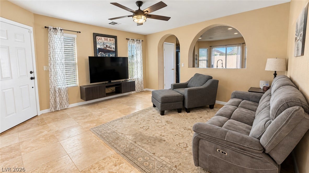 Arched doorways and tile flooring define this inviting, open living area.