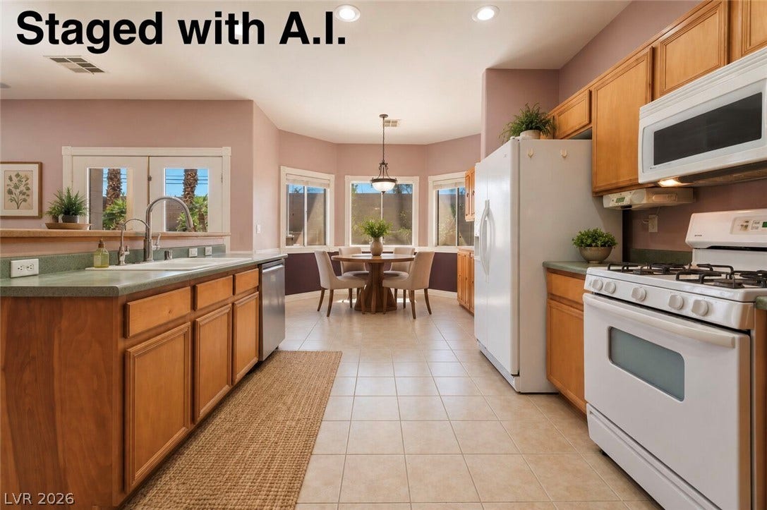 Tiled flooring flows through this kitchen and into the adjacent dining area. Staged with A.I.