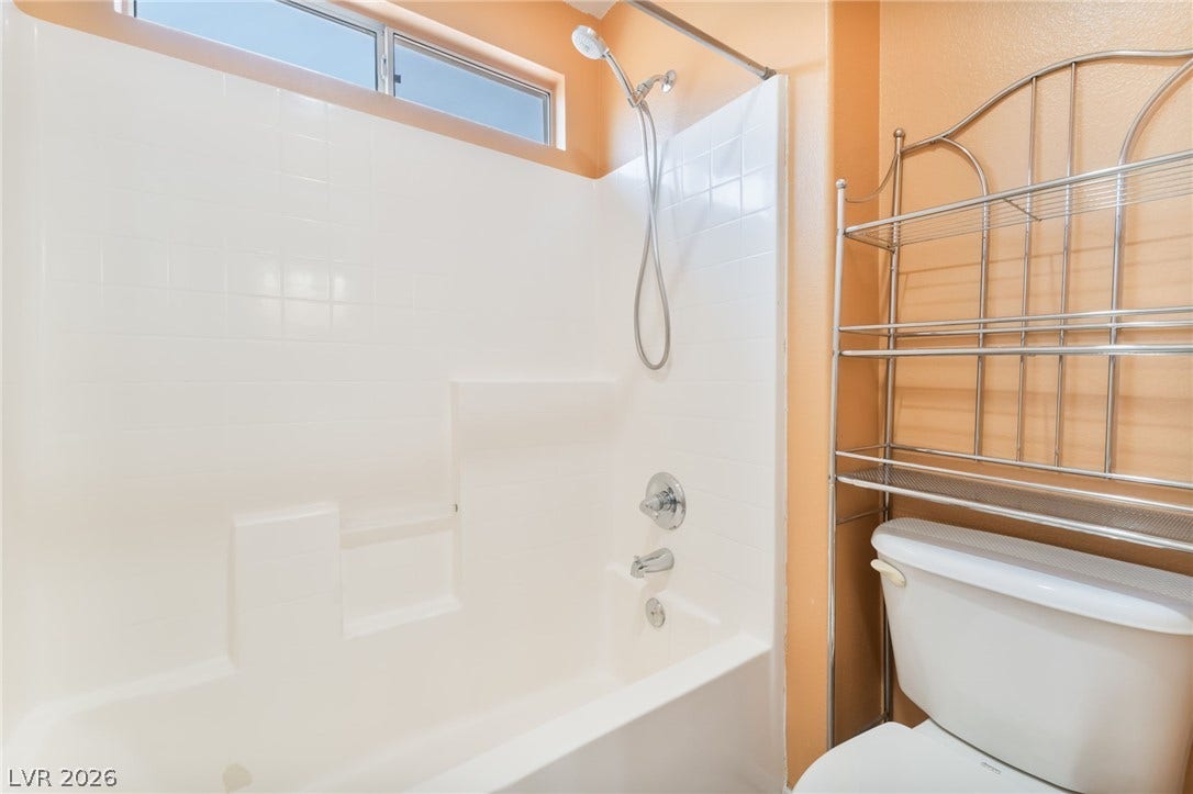 High clerestory windows bring natural light into this functional bathroom space.