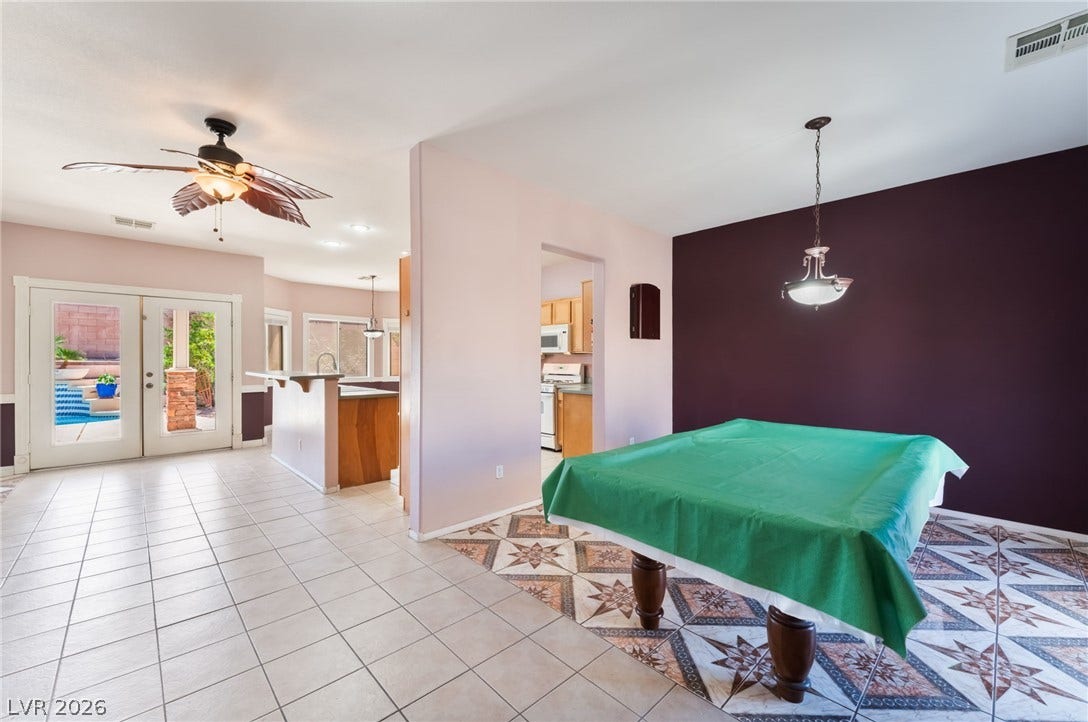 Patterned and solid tile flooring defines the distinct functional areas of this open layout.
