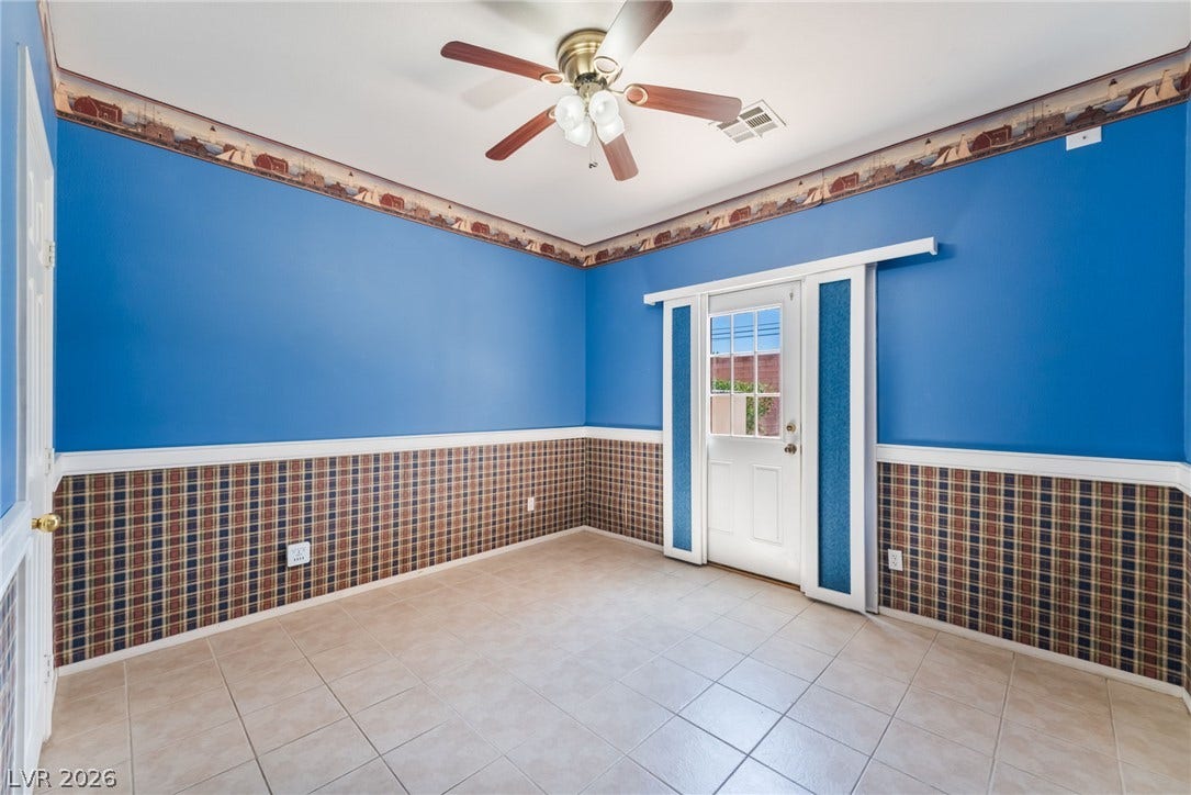 Tiled floors located on the first floor and a glass-paneled door leading to the backyard. highlight this versatile room.
