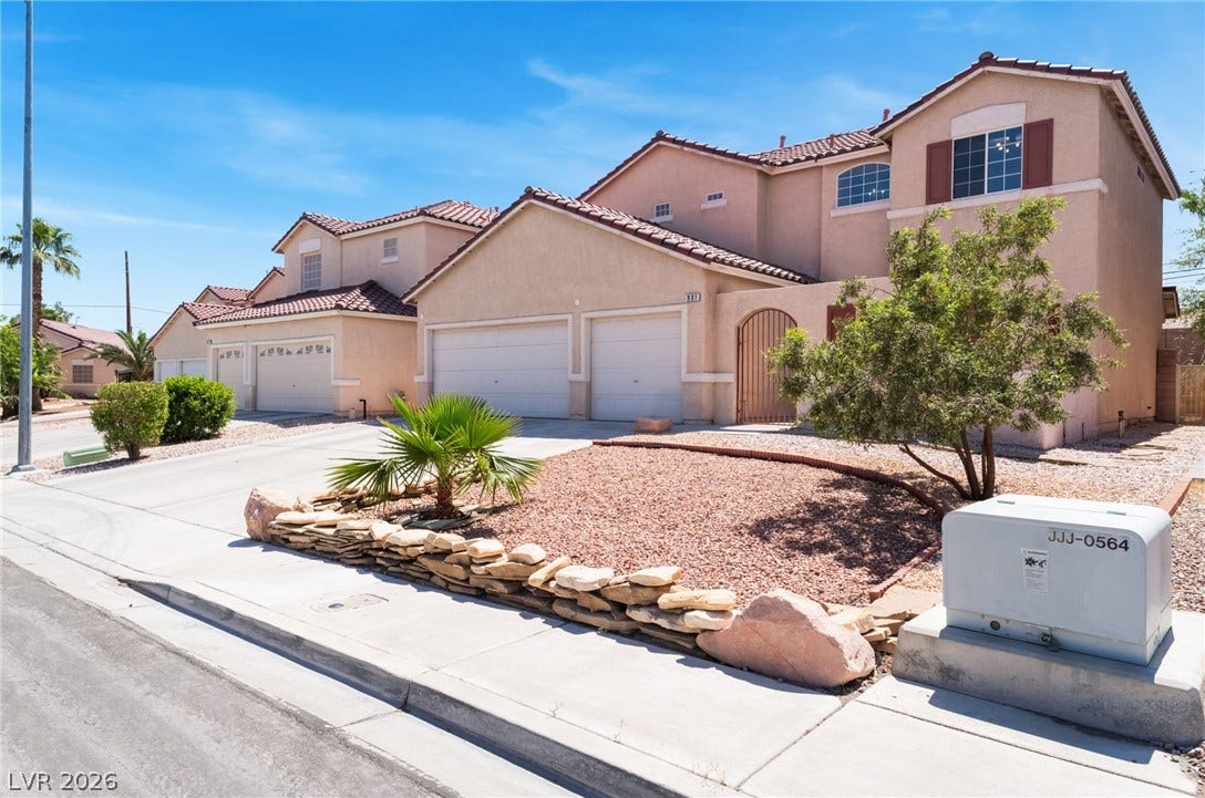 Spanish tile roofing and desert landscaping create classic southwestern curb appeal.