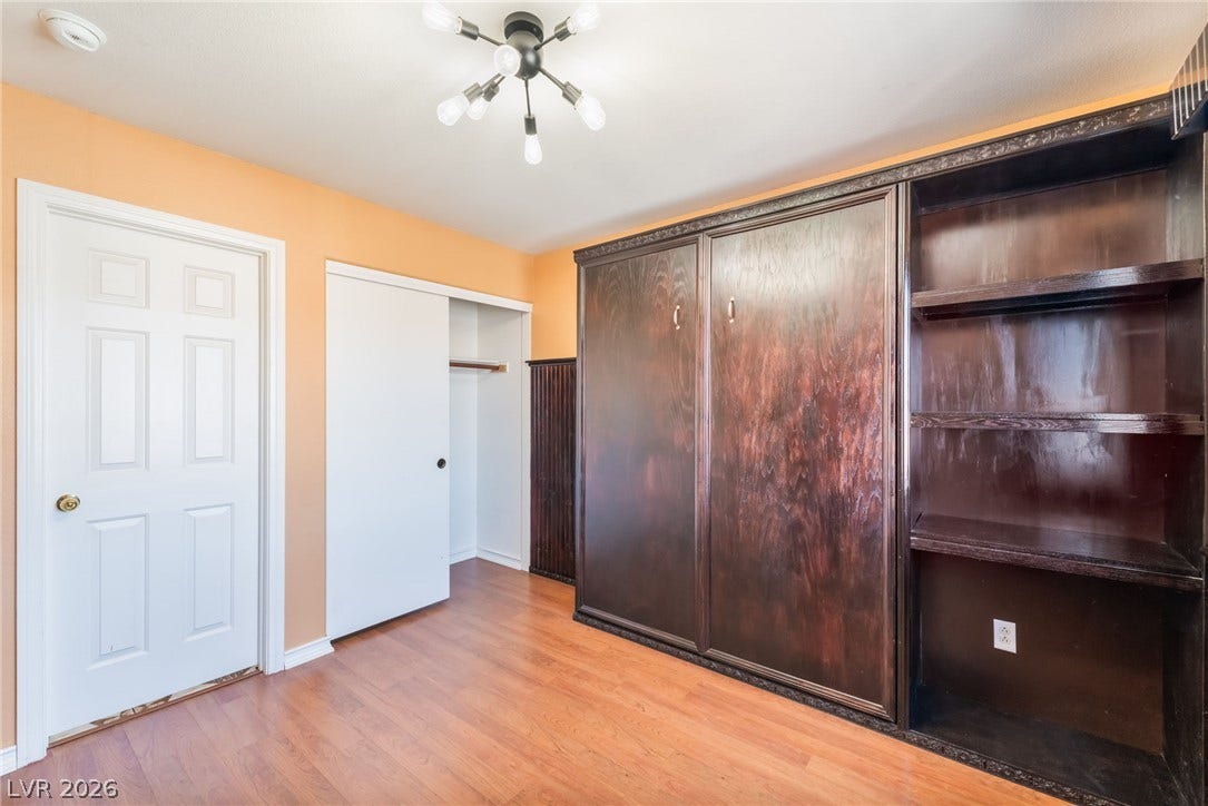 Gleaming wood flooring complements the handsome built-in storage units lining the wall. Murphy bed built in and conveys with the property!