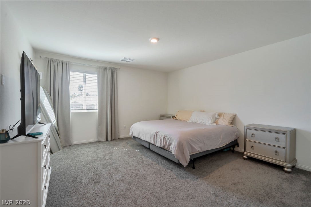 3428 Rush Avenue, Las Vegas, NV 89141 Soft carpet and natural light from a large window define this comfortable bedroom retreat.