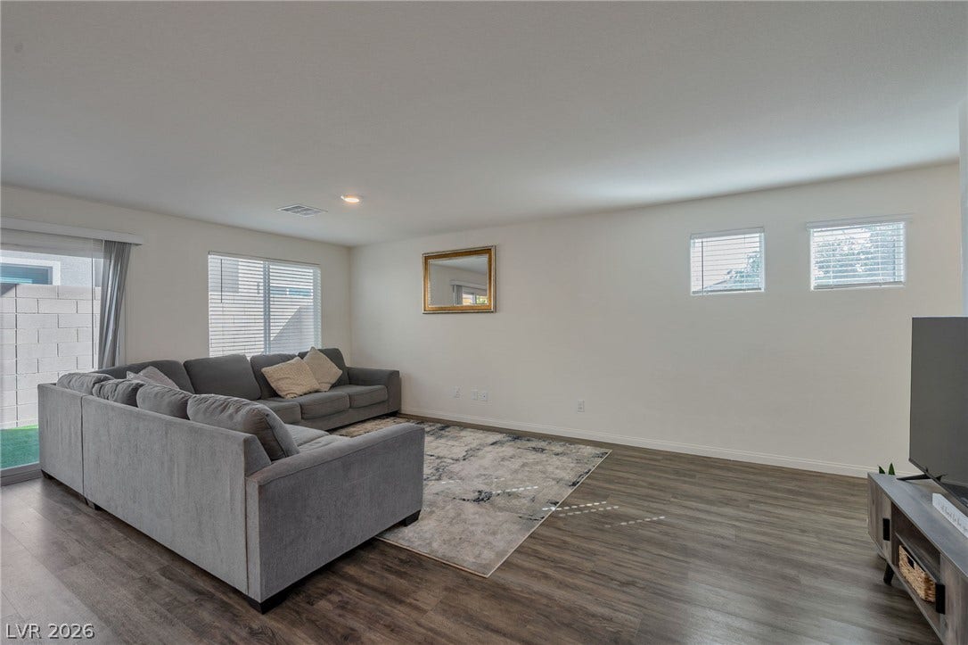 3428 Rush Avenue, Las Vegas, NV 89141 Gleaming wood-look floors anchor a spacious layout highlighted by clean walls and abundant natural light.