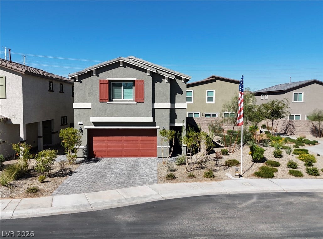 3428 Rush Avenue, Las Vegas, NV 89141 An inviting two-story stucco exterior stands out with a paved driveway and desert landscaping.