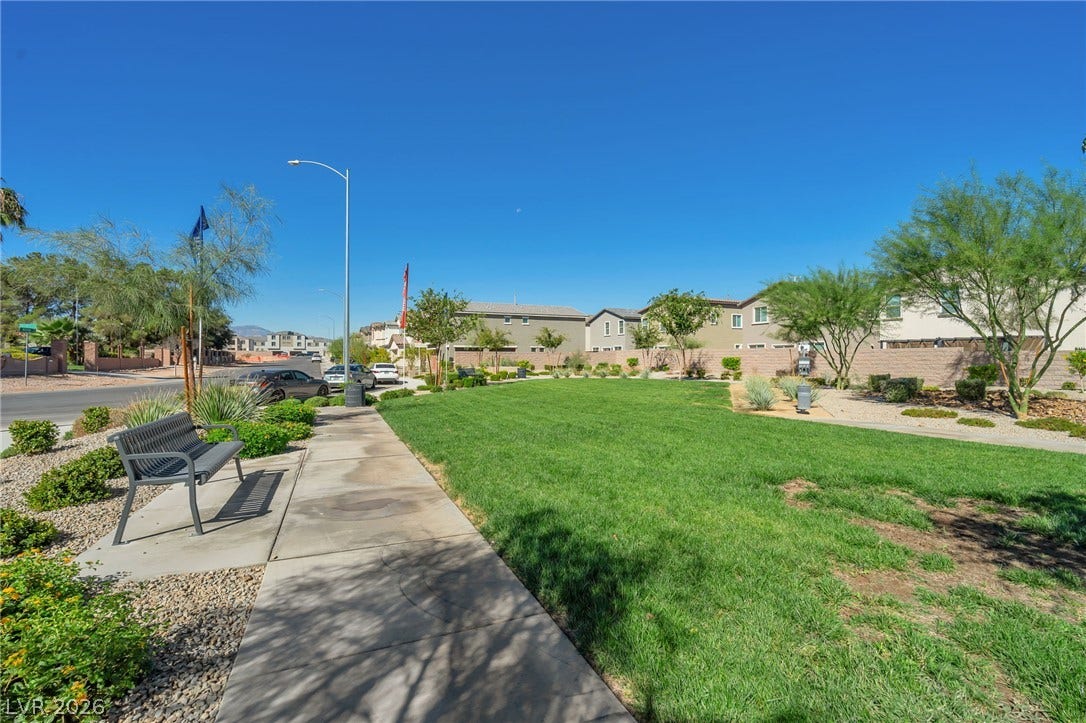 3428 Rush Avenue, Las Vegas, NV 89141 A paved sidewalk winds alongside a manicured grassy common area.
