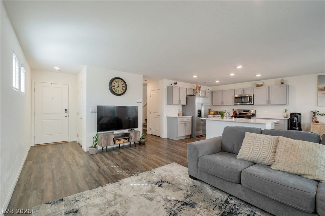 3428 Rush Avenue, Las Vegas, NV 89141 An open floorplan seamlessly connects the comfortable living space with a modern kitchen.