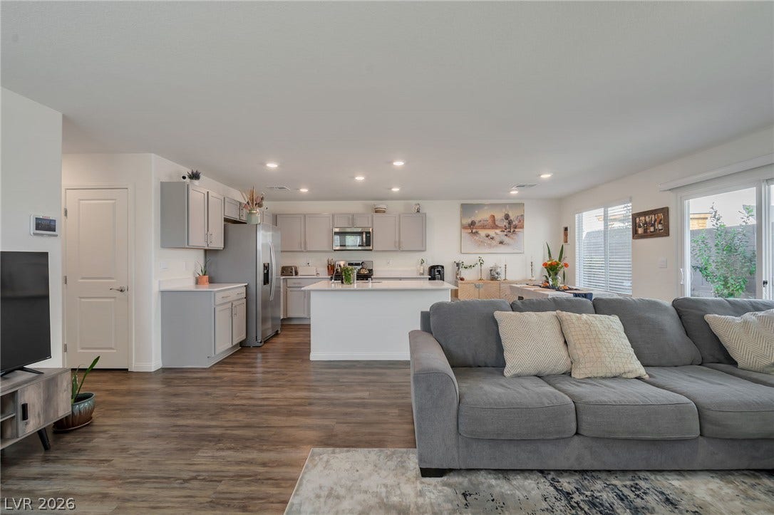 3428 Rush Avenue, Las Vegas, NV 89141 Smooth plaster ceilings and durable wood-look flooring unite this versatile open concept living space.