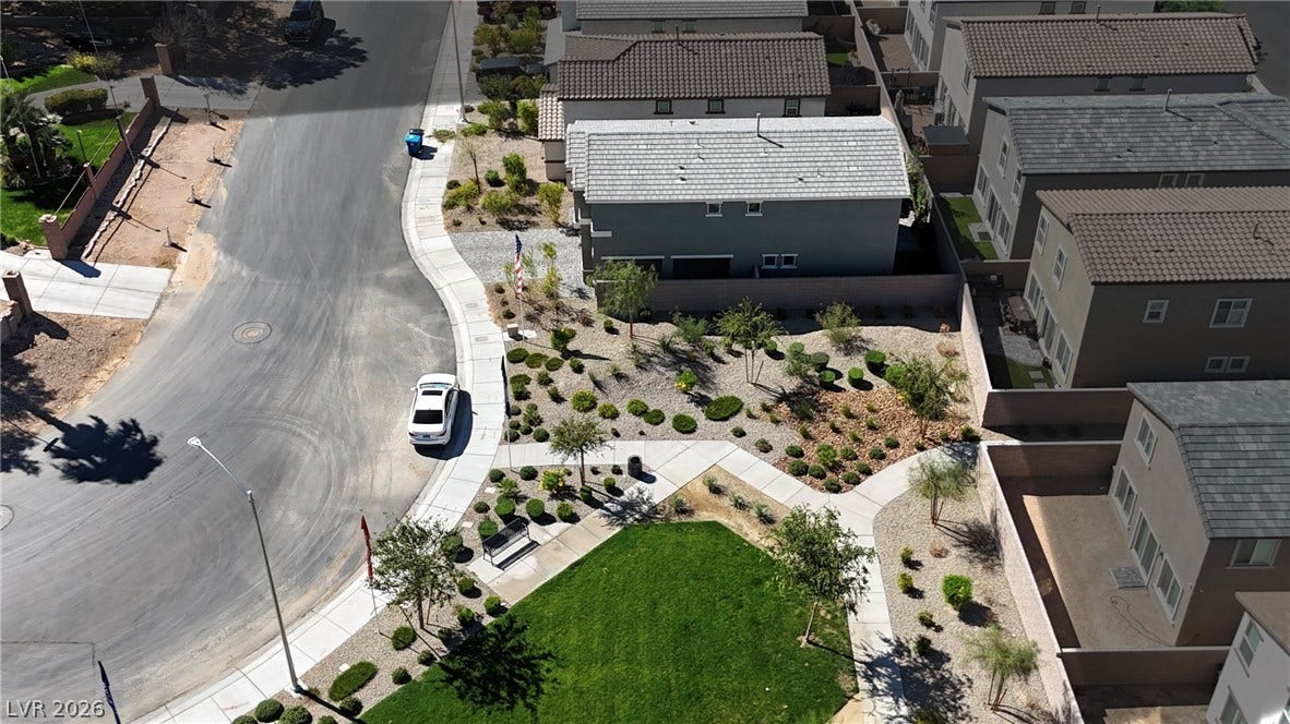 3428 Rush Avenue, Las Vegas, NV 89141 An aerial perspective shows paved walking paths weaving through manicured neighborhood greenspaces and desert landscaping.