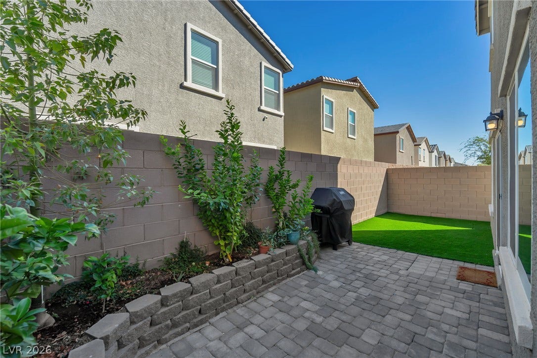 3428 Rush Avenue, Las Vegas, NV 89141 Stone pavers and a raised garden bed create an inviting outdoor space.