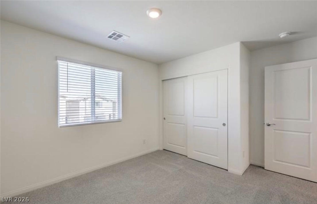 3428 Rush Avenue, Las Vegas, NV 89141 Plush carpeting and natural light define this clean, modern bedroom space.