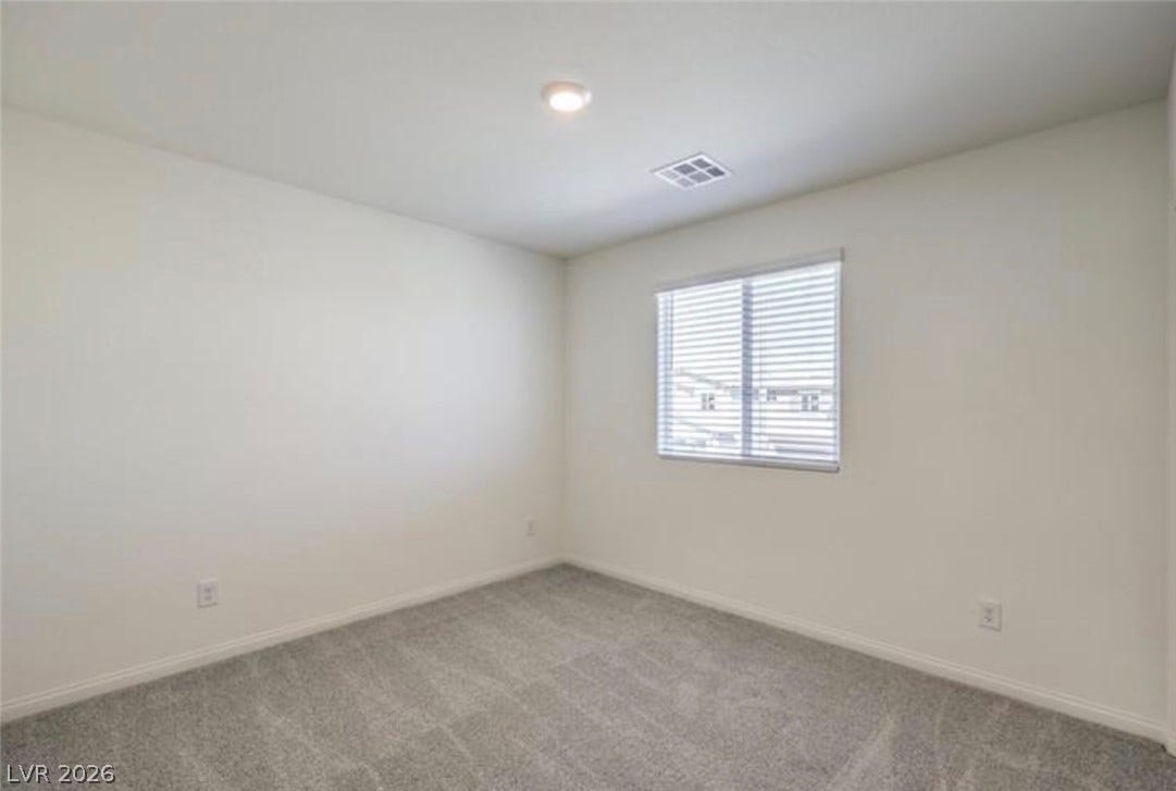 3428 Rush Avenue, Las Vegas, NV 89141 Plush carpeting anchors this versatile room under a smooth ceiling with recessed lighting.