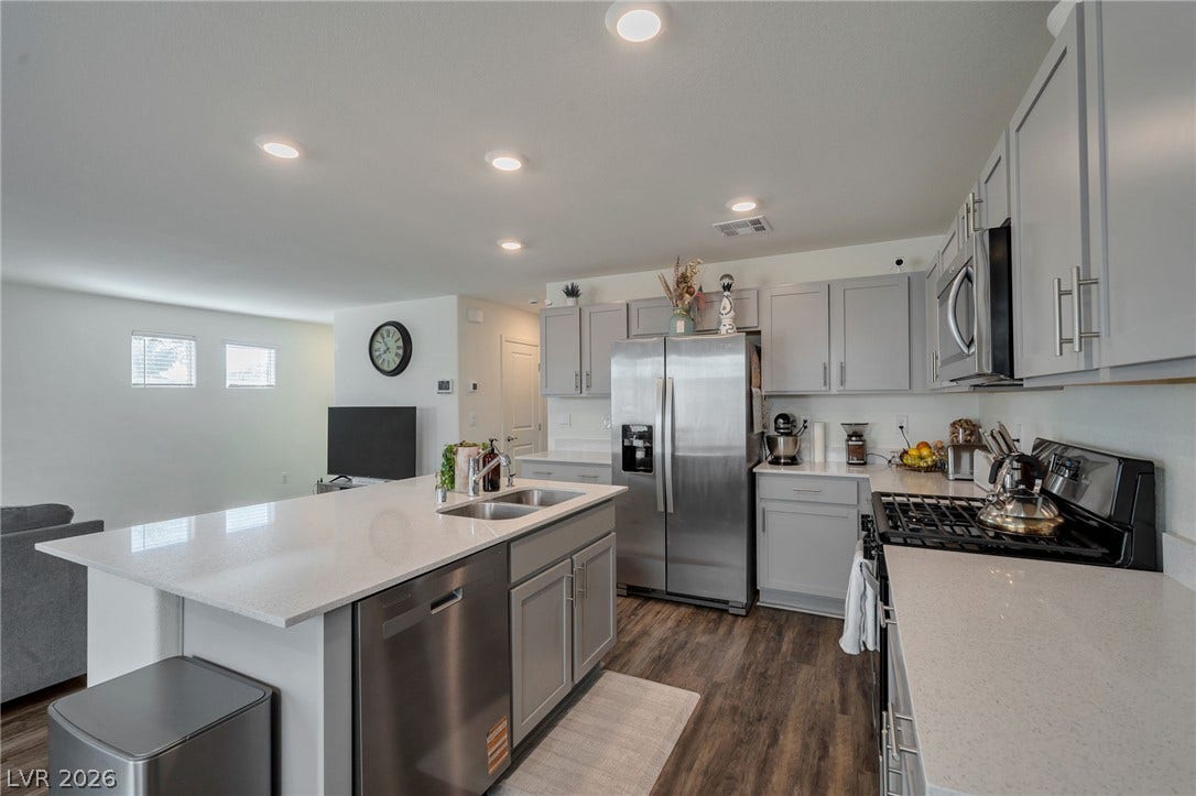 3428 Rush Avenue, Las Vegas, NV 89141 An open kitchen boasts premium quartz countertops alongside a functional preparation island.