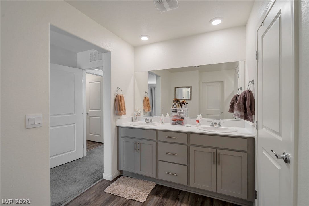 3428 Rush Avenue, Las Vegas, NV 89141 Clean lines and a spacious dual vanity define this modern bathroom layout.