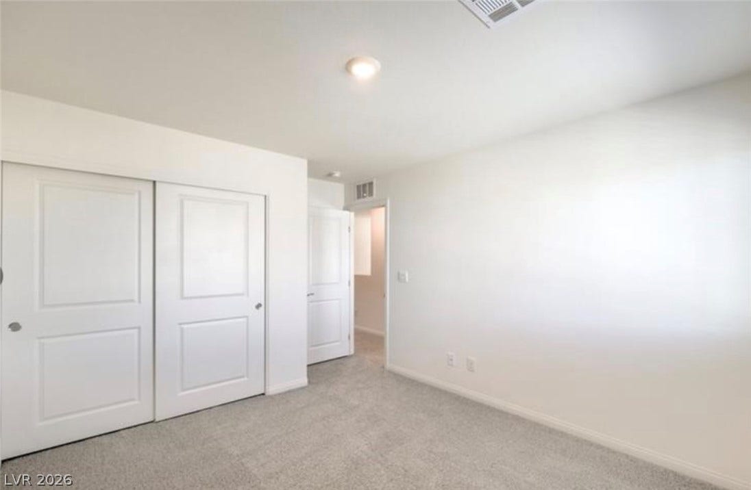 3428 Rush Avenue, Las Vegas, NV 89141 Plush carpeting and clean lines define this serene bedroom space.