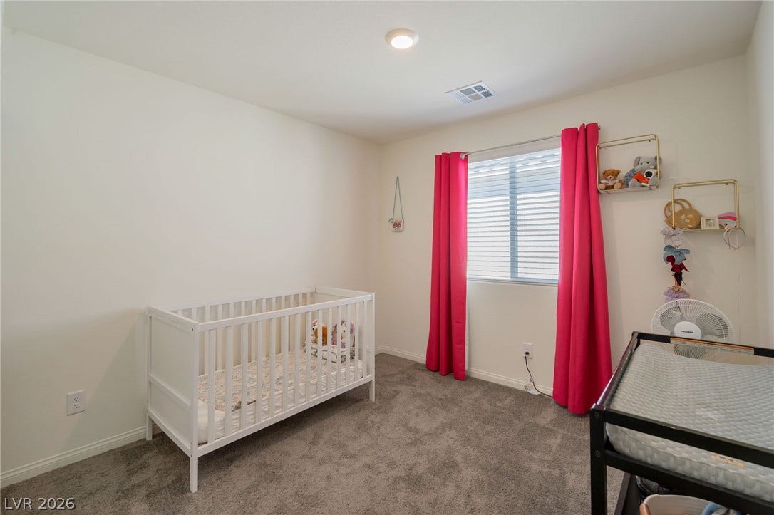 3428 Rush Avenue, Las Vegas, NV 89141 Plush carpeting and natural light define this cozy secondary bedroom space.