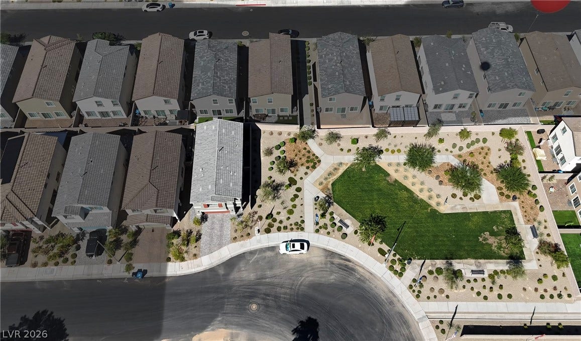 3428 Rush Avenue, Las Vegas, NV 89141 An aerial perspective captures a beautifully landscaped neighborhood park nestled among contemporary suburban homes.