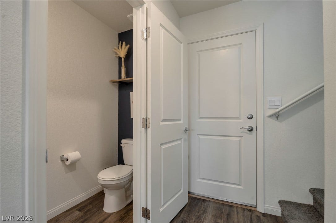 3428 Rush Avenue, Las Vegas, NV 89141 Crisp panel doors complement the wood-look flooring near the compact powder room and staircase.
