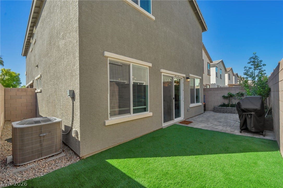 3428 Rush Avenue, Las Vegas, NV 89141 An inviting backyard features a paved patio alongside a low-maintenance artificial turf lawn.