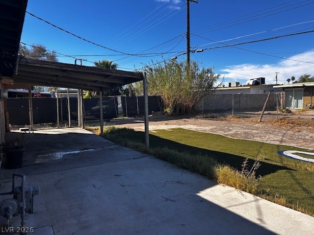 3708 Perliter Avenue, North Las Vegas, NV 89030 An expansive outdoor concrete area connects directly to a covered patio structure under sunny skies.