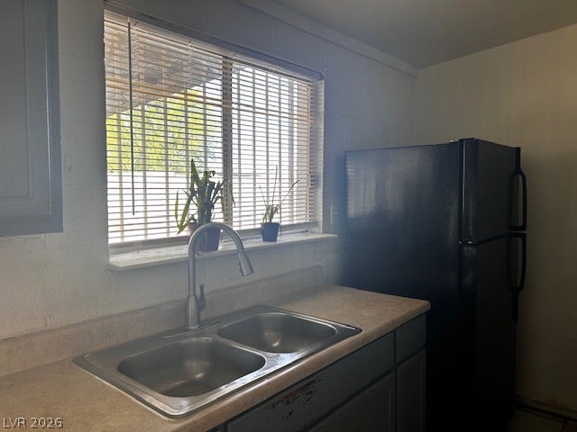 3708 Perliter Avenue, North Las Vegas, NV 89030 Natural light streams through the window above a double-basin sink and laminate countertop.