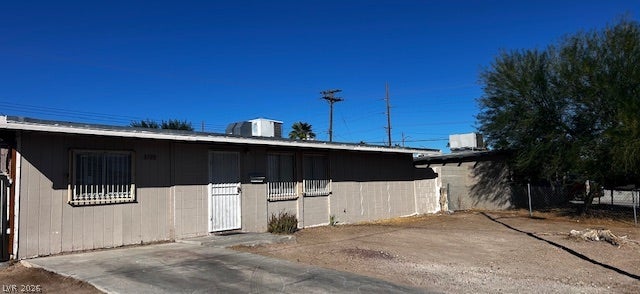 3708 Perliter Avenue, North Las Vegas, NV 89030 A classic single-story exterior features vertical siding and a concrete driveway under clear blue skies.