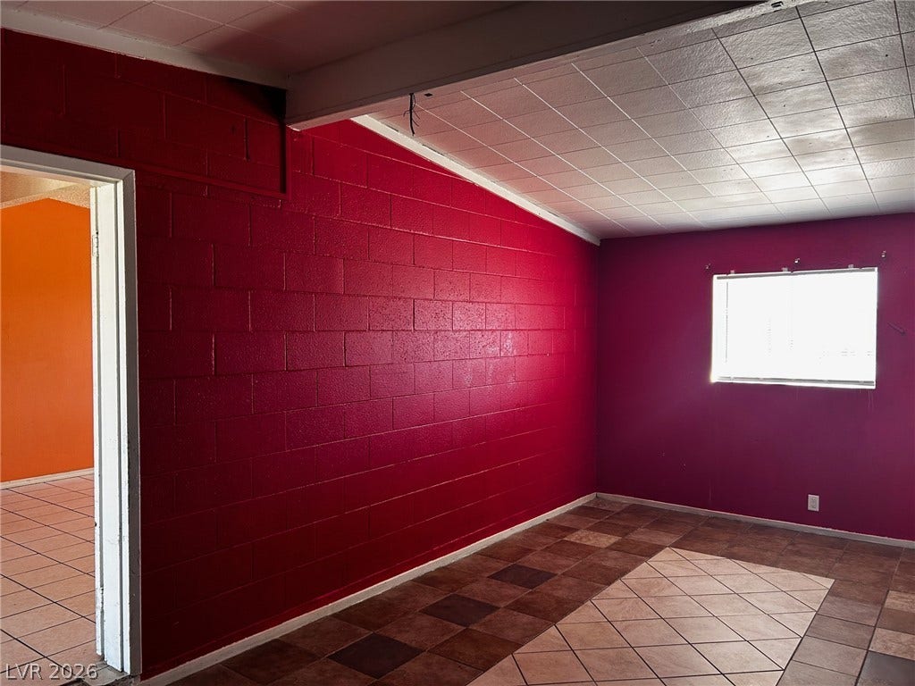 3708 Perliter Avenue, North Las Vegas, NV 89030 Tiled floors and a prominent structural beam define this versatile interior space.