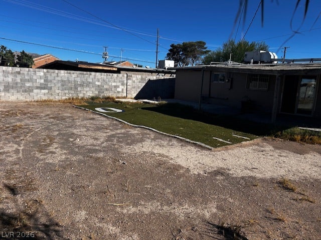 3708 Perliter Avenue, North Las Vegas, NV 89030 A block wall encloses this desert backyard featuring a small patch of synthetic turf.